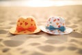 two sunhats with heart patterns lying on sand Royalty Free Stock Photo