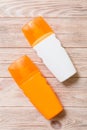 Two Sunscreen bottles on a bright wooden background, top view Royalty Free Stock Photo