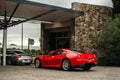 Rear view of two exotic cars. Ferrari and Porsche.