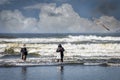 two surf fisherman fishing in the ocean waves Royalty Free Stock Photo