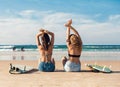 Two surfer girls at the beach Royalty Free Stock Photo