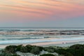 Two surfers sitting on Betty`s Bay beach at sunset in the Western Cape, South Africa Royalty Free Stock Photo