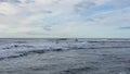 Two surfers glide on the waves of the Pacific Ocean