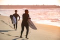 Two surfers run in the beach Royalty Free Stock Photo