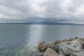 Two surfers are swimming on a surfboard in the waters of Dublin bay. Royalty Free Stock Photo