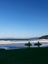 Two surfers walking on a beach in California