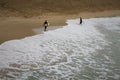 Two surfers walking out of the sea