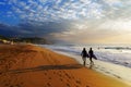 Two surfers walking on Sopelana beach Royalty Free Stock Photo