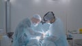Two surgeons perform operation on man. Action. Surgeons professionally perform operation on patient under anesthesia Royalty Free Stock Photo