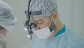 Two surgeons work together in operating room. Action. Couple of professional surgeons during operation. Bright operating