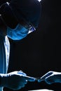 Two surgeons working and passing surgical equipment in the operating room, dark, close-up Royalty Free Stock Photo