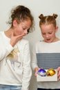 Two Surprised young teenage girl with hair bun over white background.