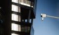 Two surveillance cameras in the front of an office building. Royalty Free Stock Photo