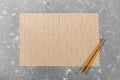 Two sushi chopsticks with empty bamboo mat or wood plate on cement Background Top view with copy space. empty asian food Royalty Free Stock Photo