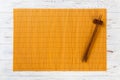 Two sushi chopsticks with empty yellow bamboo mat or wood plate on white wooden Background Top view with copy space. empty asian Royalty Free Stock Photo