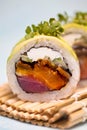 Two Sushi Rolls on a Plate With Chopsticks Royalty Free Stock Photo
