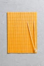 Two sushi training sticks with empty bamboo mat or wood plate on stone Background Top view with copy stace Royalty Free Stock Photo