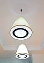 Two suspended ceiling lamps on the matte ceiling in the corridor Royalty Free Stock Photo