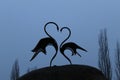 Two swans stand on a heart-shaped stone. Mother`s Day card, Valentine`s Day Valentine`s Day Royalty Free Stock Photo