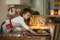 Two sweet children, boy brothers, preparing gingerbread cookies