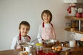 Two sweet children, boy brothers, preparing gingerbread cookies Royalty Free Stock Photo