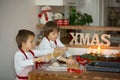 Two sweet children, boy brothers, preparing gingerbread cookies Royalty Free Stock Photo