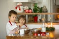 Two sweet children, boy brothers, preparing gingerbread cookies Royalty Free Stock Photo