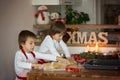 Two sweet children, boy brothers, preparing gingerbread cookies Royalty Free Stock Photo