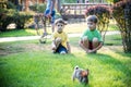 Two sweet little boy and Pennon rabbit bunnies are sitting on green grass. Friendship between humans and animals. Children and Royalty Free Stock Photo