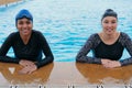 Two swimmers preparing to race at the swimming pool Royalty Free Stock Photo