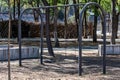 Two swings on an arched metal tube base, outdoor recreation area for children in a public park Royalty Free Stock Photo