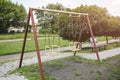 Two swings on children playground. Outdoors games for kids Royalty Free Stock Photo