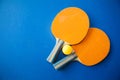 Two table tennis or ping pong rackets and balls on a blue table Royalty Free Stock Photo