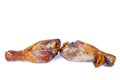 Two tainted smoked chicken legs on a white