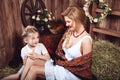 Two talking countrywomen sitting on the haystack