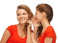 Two talking teenage girls in red t-shirts Royalty Free Stock Photo