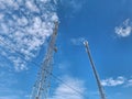 Two tall cell towers on blue background Royalty Free Stock Photo