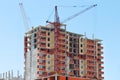 Two tall cranes and brick building under construction Royalty Free Stock Photo