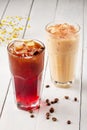 Two tall glasses with cold coffee cocktails on light wooden table. Cold coffee cocktails Royalty Free Stock Photo