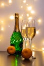 Two tall glasses with sparkling wine, tangerines, garlands, New Year mood and Christmas. Royalty Free Stock Photo