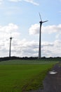 two tall wind power plants in rural landscape
