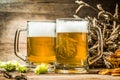 Two tankard beer closeup on wooden table