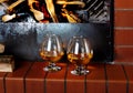 Two tanks of cognac on the old brick fireplace Royalty Free Stock Photo