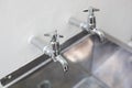 Two taps and stainless steel kitchen sink Royalty Free Stock Photo
