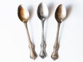 Two tarnished and one clean vintage silver spoons