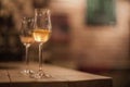 Two tasting glasses of whiskey served on wooden planks.