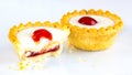Two Bakewell Tarts with white icing and a red cherry. Royalty Free Stock Photo