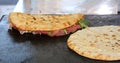 Two tasty piadines stuffed with ham and cheese on the hot plate Royalty Free Stock Photo