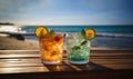 Two tasty refreshing tropical cocktails with beautiful ocean view for summer vacation. Two glasses with cocktails and Royalty Free Stock Photo