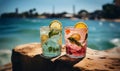 Two tasty refreshing tropical cocktails with beautiful ocean view for summer vacation. Two glasses with cocktails and Royalty Free Stock Photo